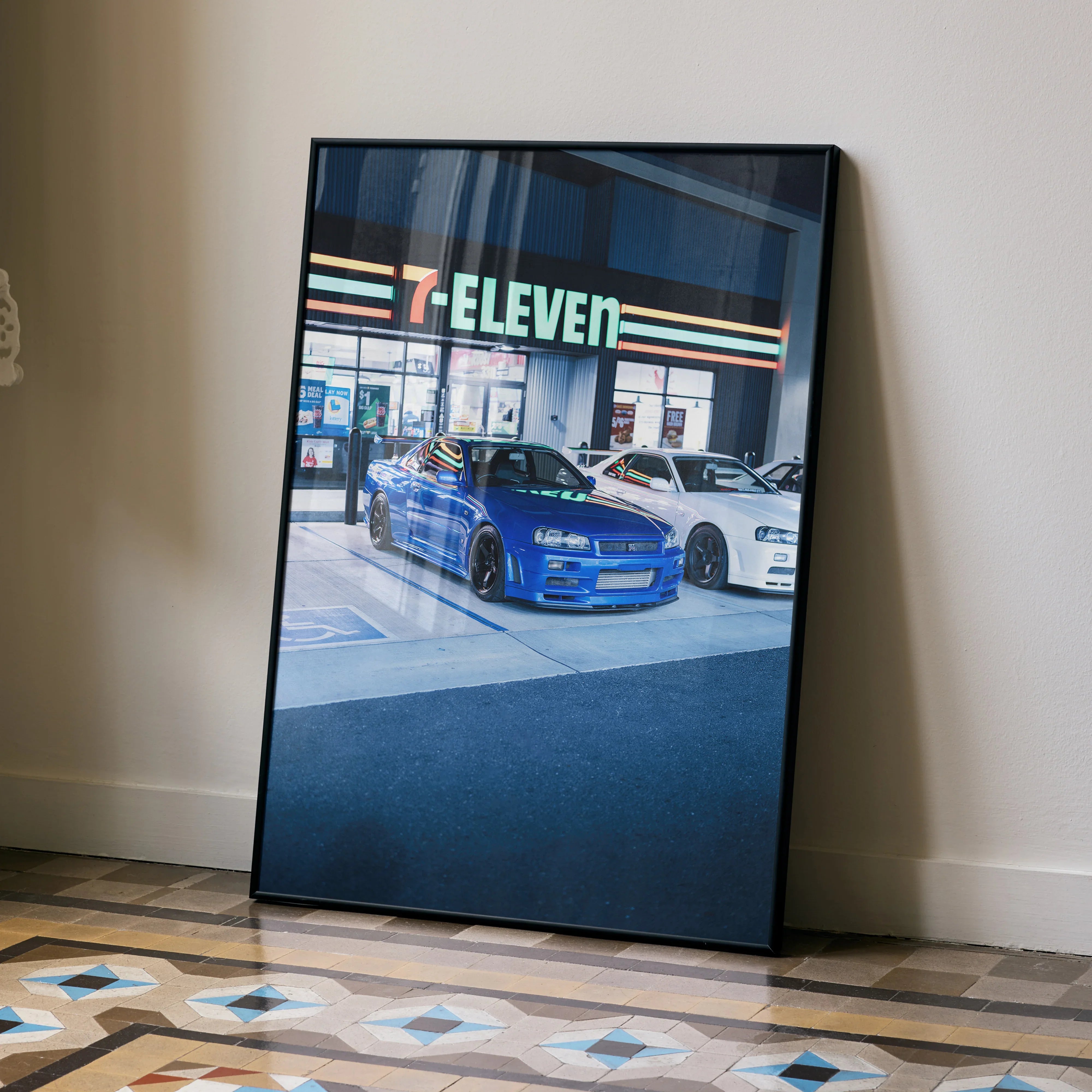 Nissan R34 GTR skyline parked outside 7-Eleven store poster wall art in black frame.