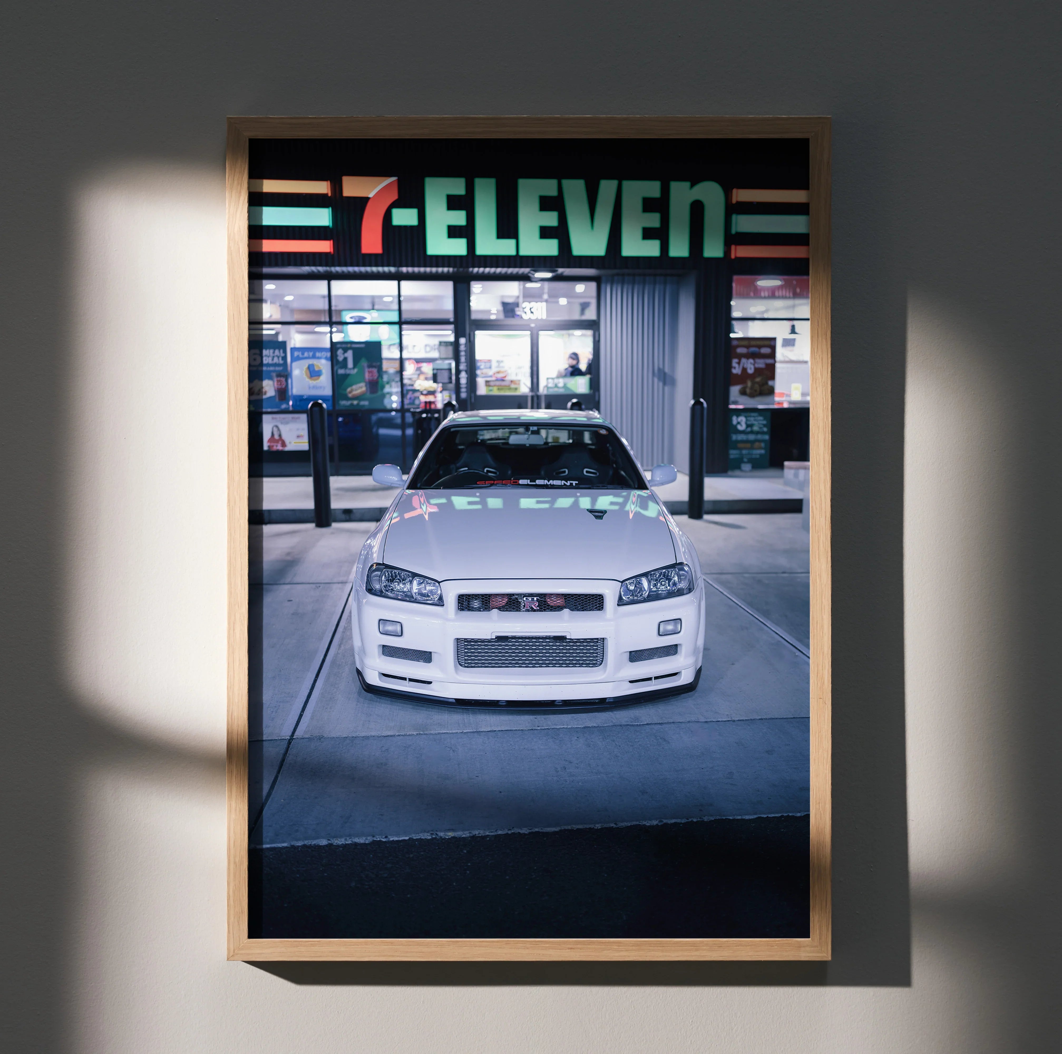 White Nissan GTR R34 Skyline poster displayed as automotive wall art in wooden frame.