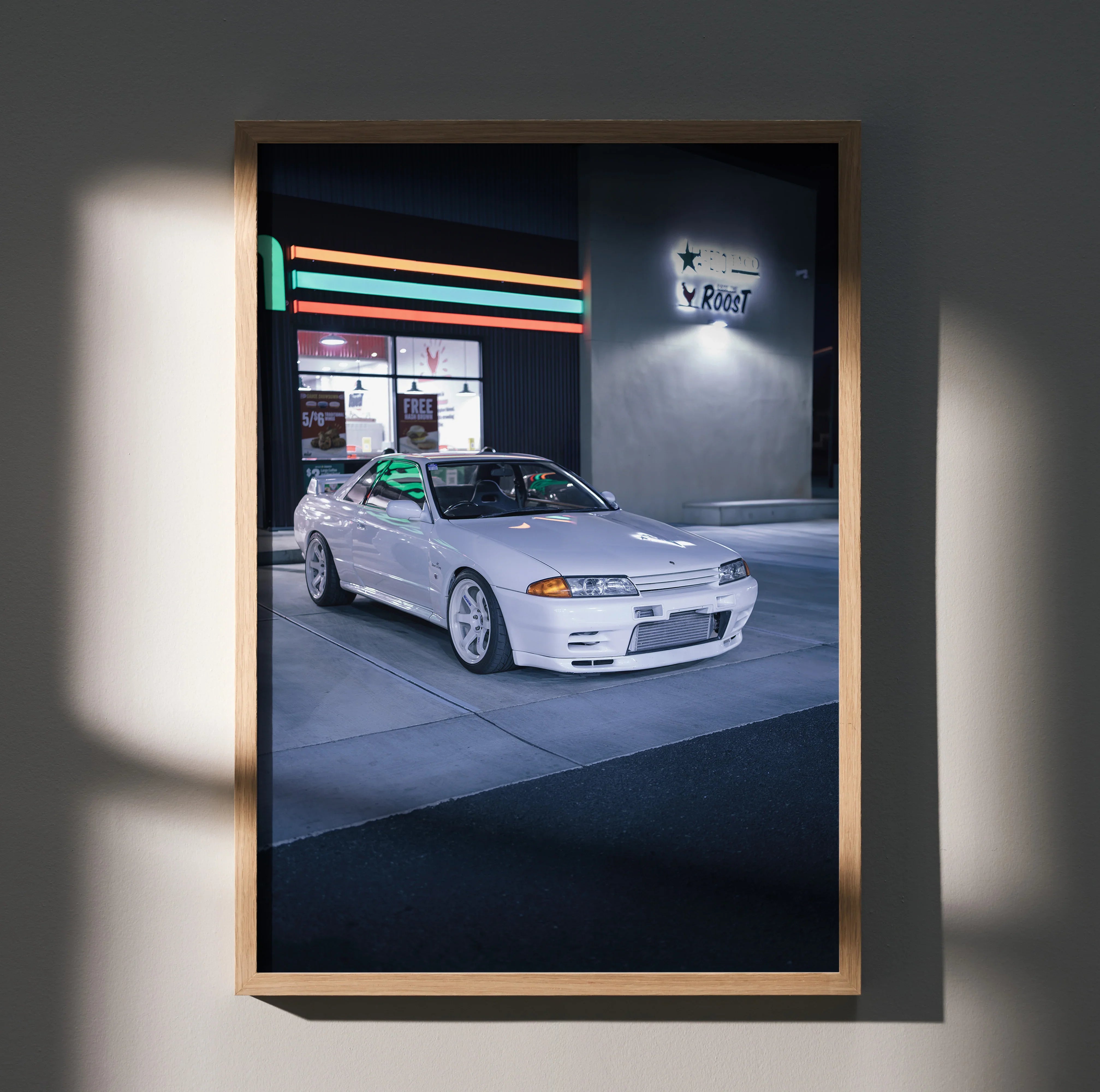 Nissan GTR R32 Skyline poster showing white vintage car parked under neon light, stylish wall art decor.