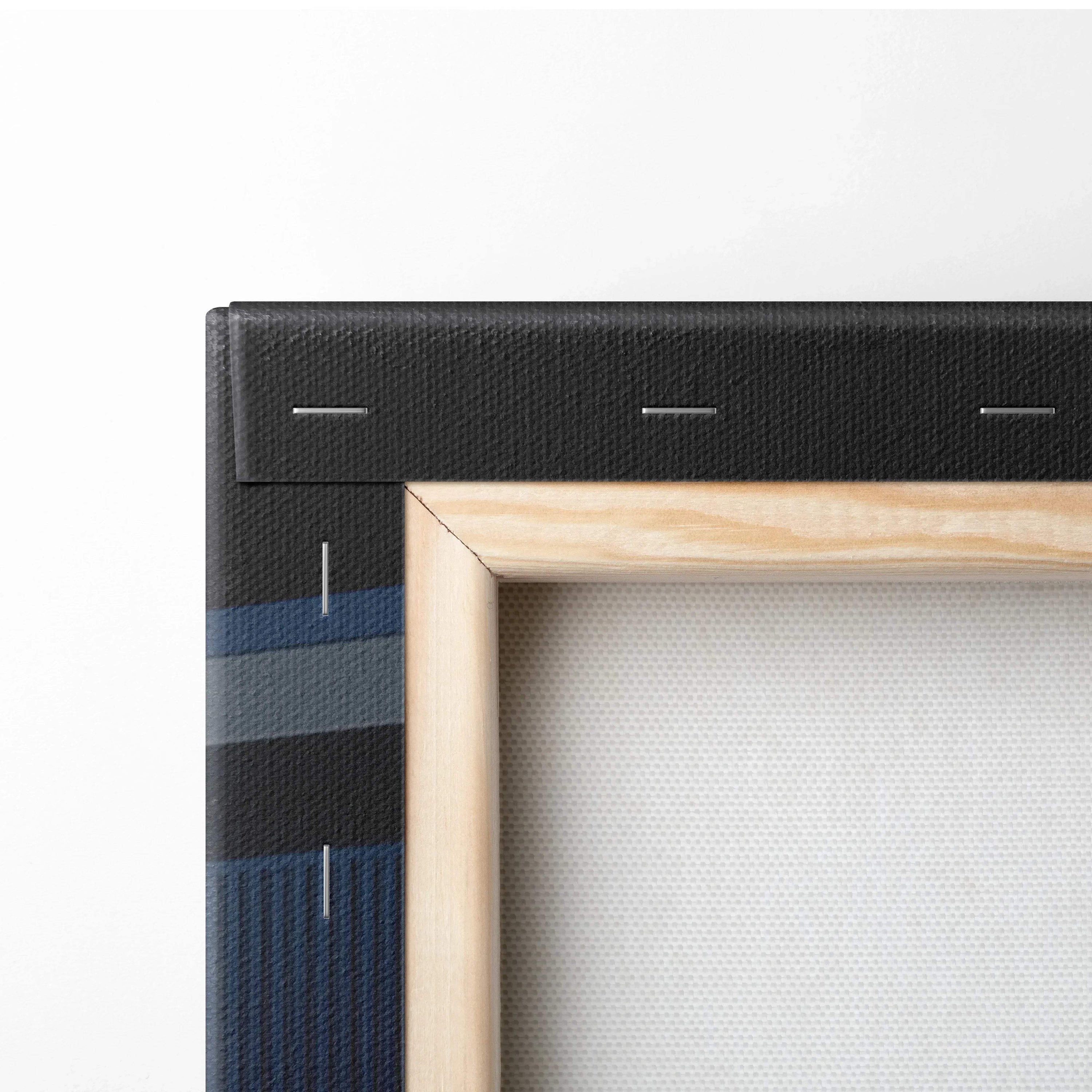Close-up of wooden frame and black stretcher bars on vertical canvas wall art with white textured surface.