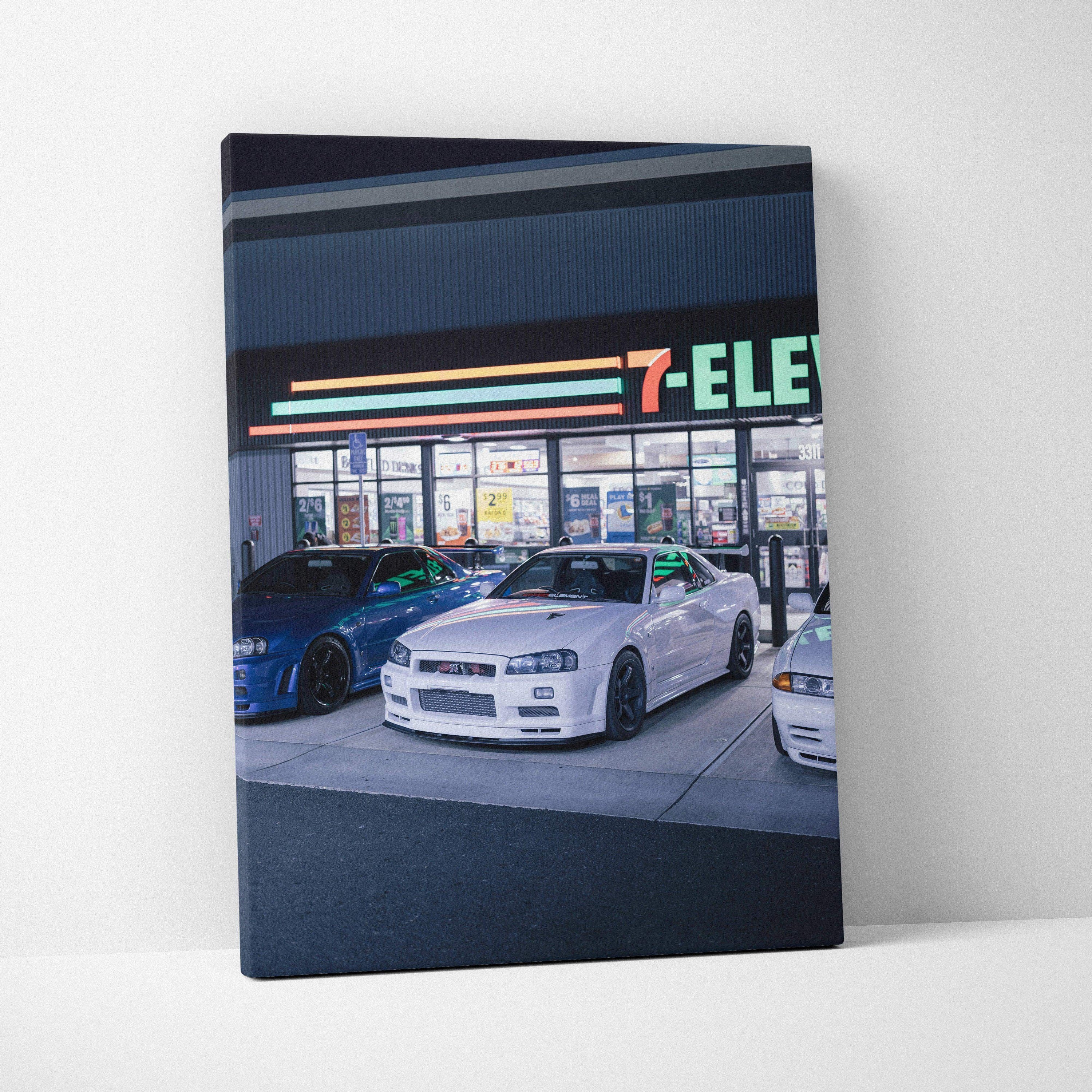 Nissan GTR R34 Skyline white car parked in front of 7-Eleven at night canvas wall art.
