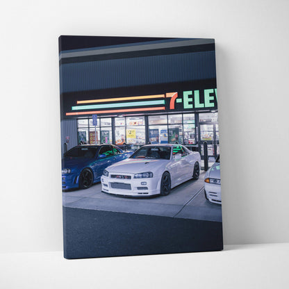 Nissan GTR R34 Skyline white car parked in front of 7-Eleven at night canvas wall art.