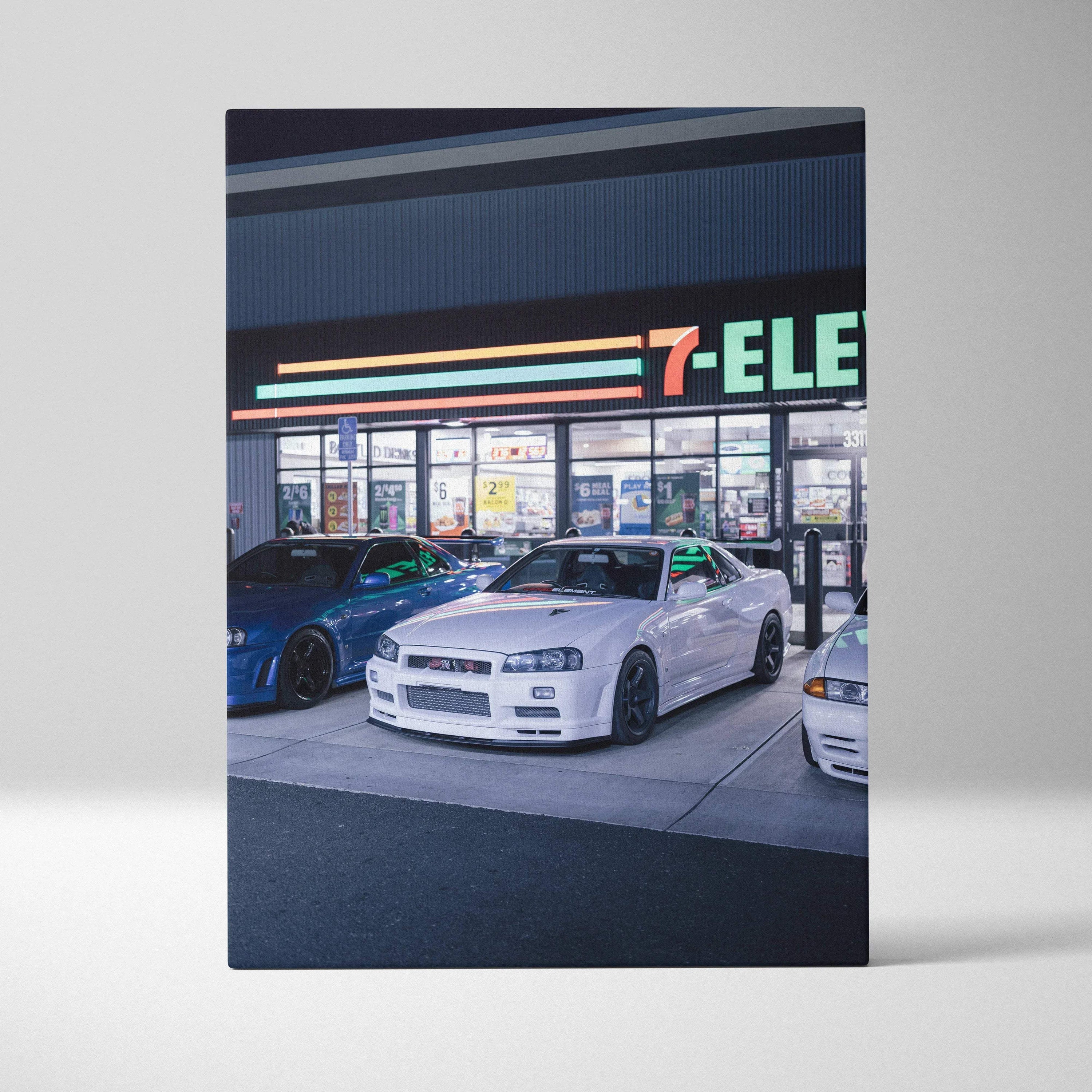 Vertical canvas art of a white Nissan GTR R34 Skyline parked outside a 7-Eleven at night wall art.
