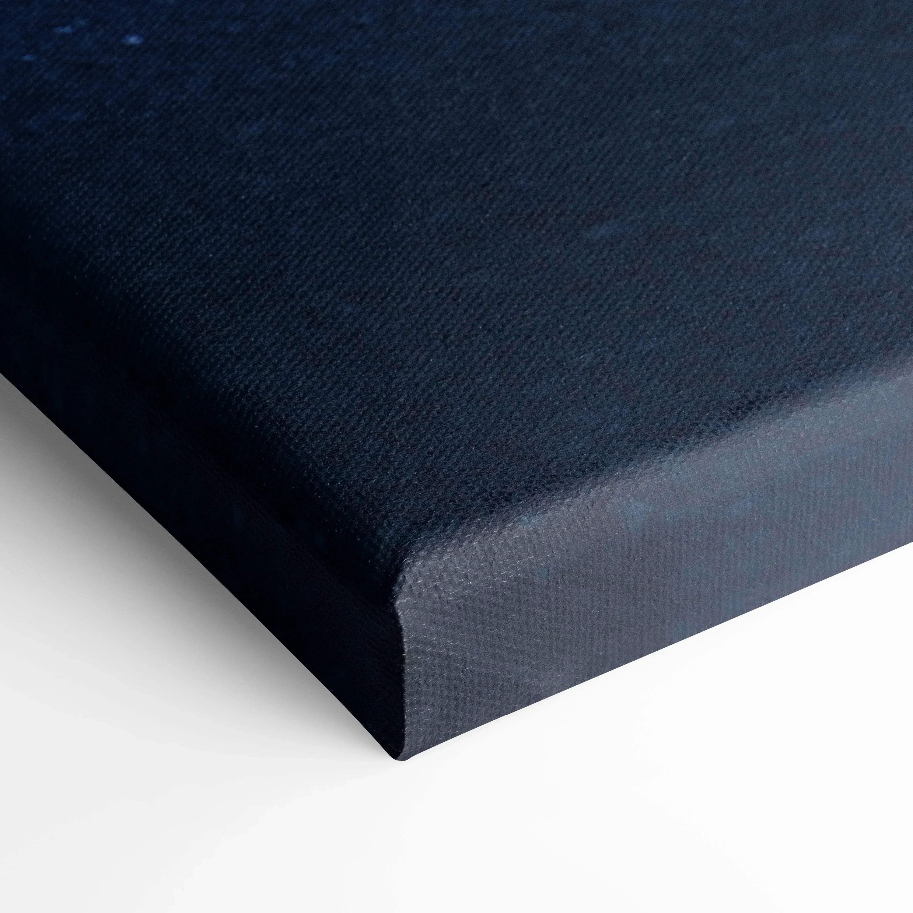 Close-up of black textured canvas wrap with sharp edges for wall art display.