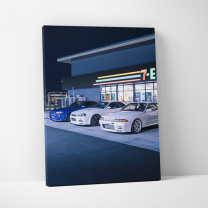Vertical canvas wall art featuring Nissan GTR R34 Skyline cars parked at night outside a convenience store.