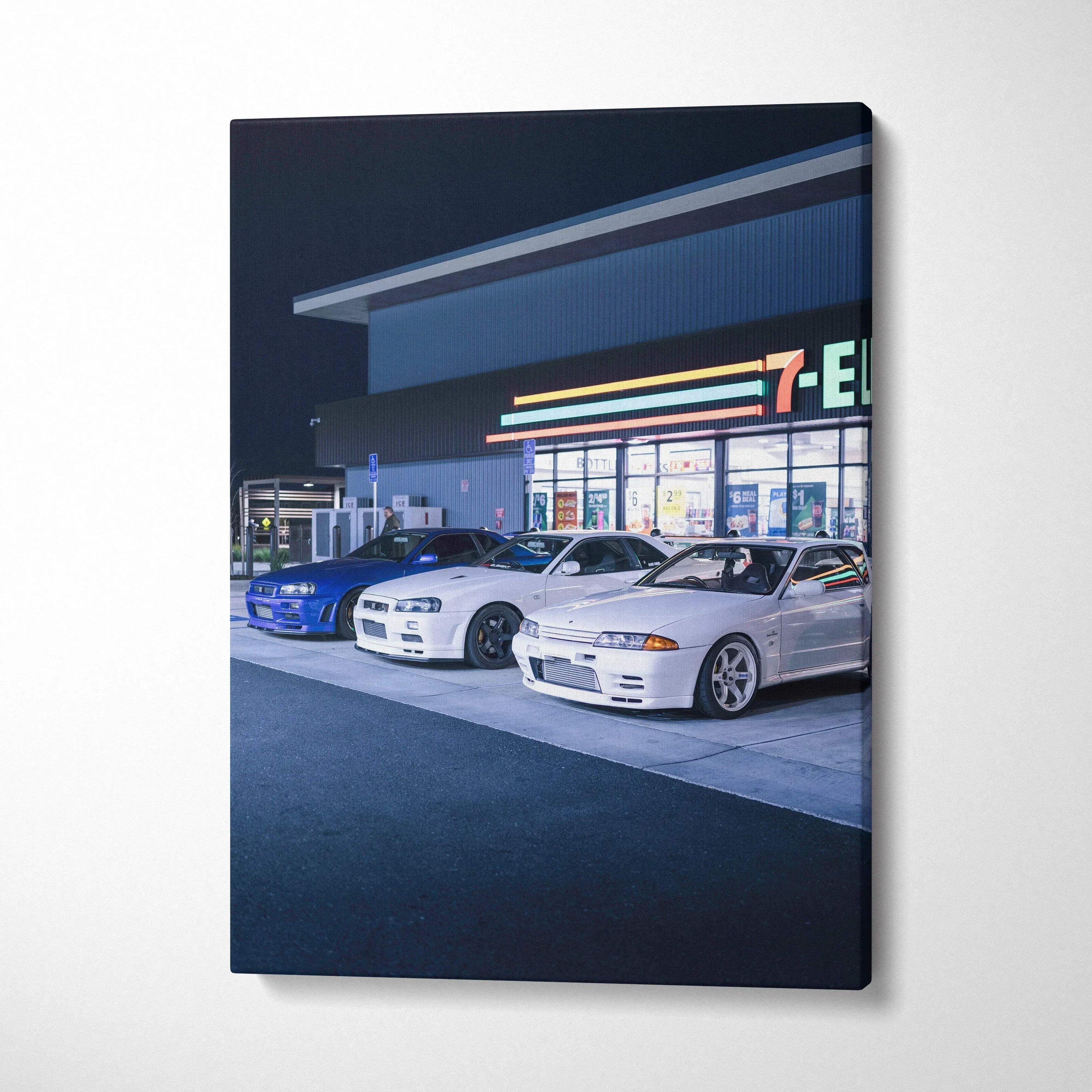 Vertical canvas art featuring Nissan GTR R34 Skyline cars parked at a gas station at night, modern wall art.