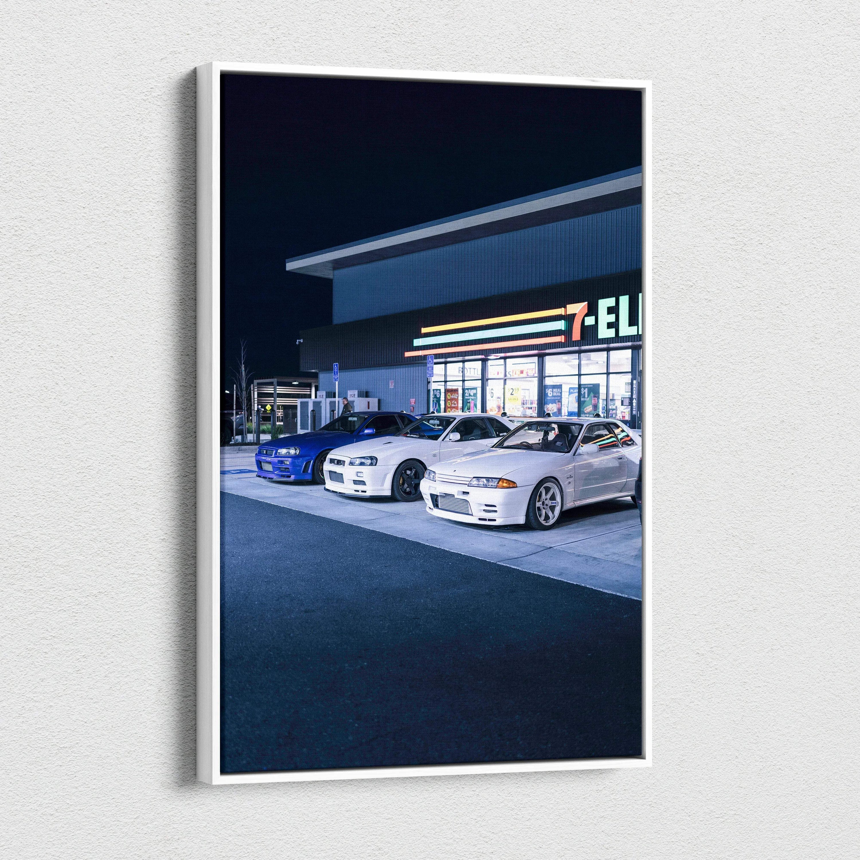 Vertical canvas art featuring Nissan GTR R34 Skyline cars parked outside a 7-Eleven at night wall art.