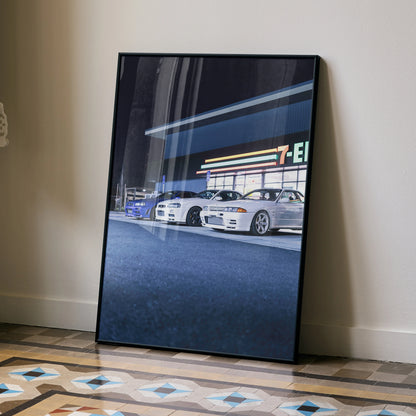Nissan GTR R32 and R34 Skyline cars in front of a 7-Eleven at night poster wall art in black frame.
