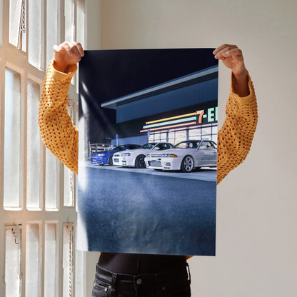 Nissan GTR R32 and R34 Skyline poster showing two white cars in front of a 7-Eleven at night wall art.