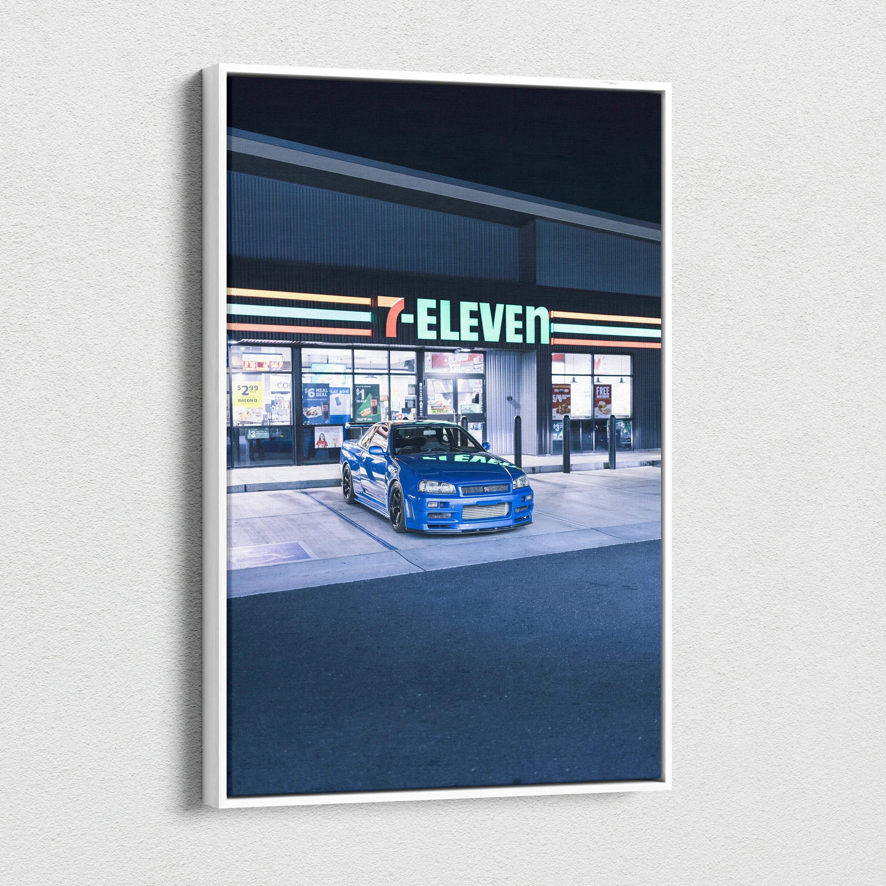 Vertical canvas art of blue Nissan GTR R34 Skyline parked at a 7-Eleven store at night wall art.