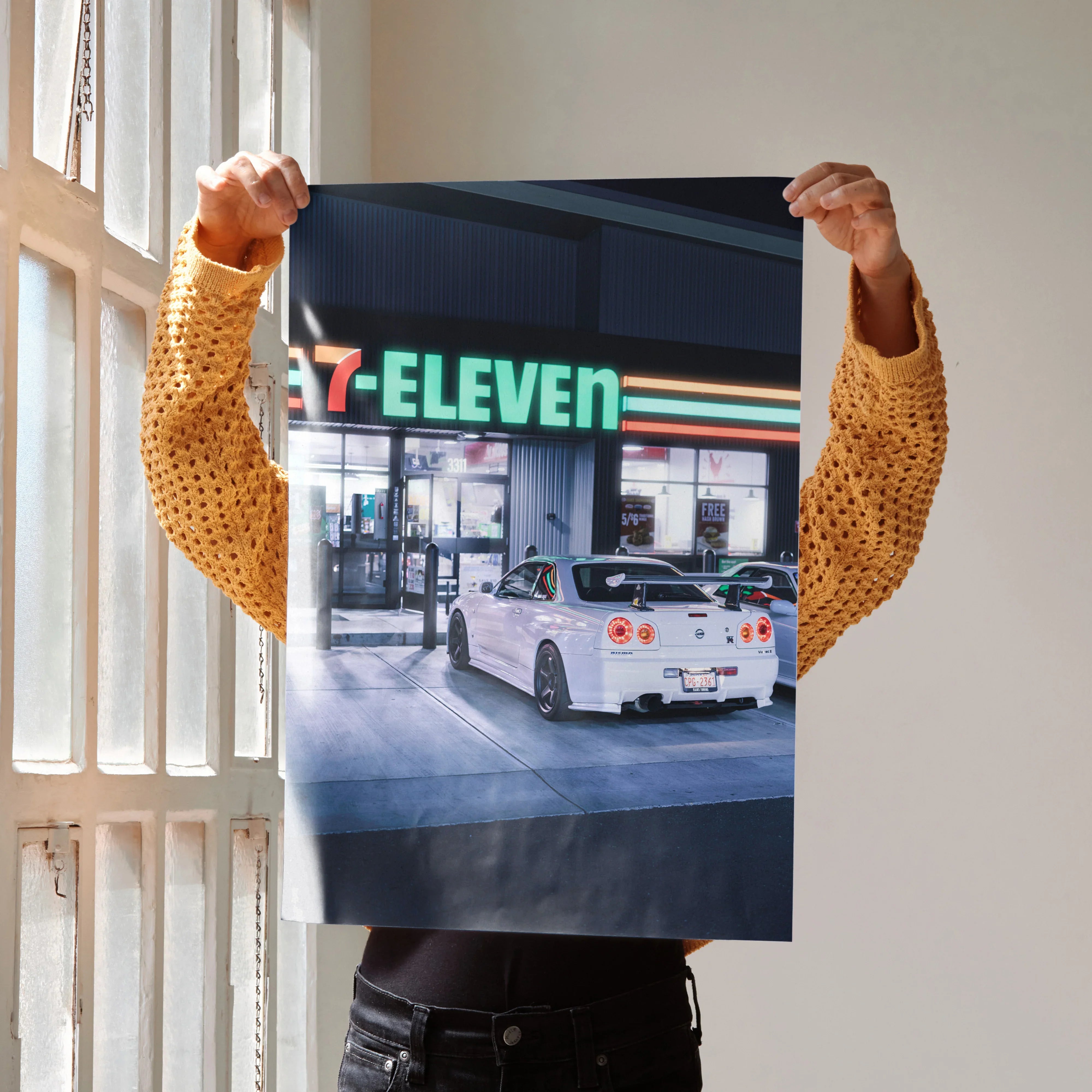 Nissan GTR R34 Skyline JDM poster with white car at 7-Eleven gas station wall art.