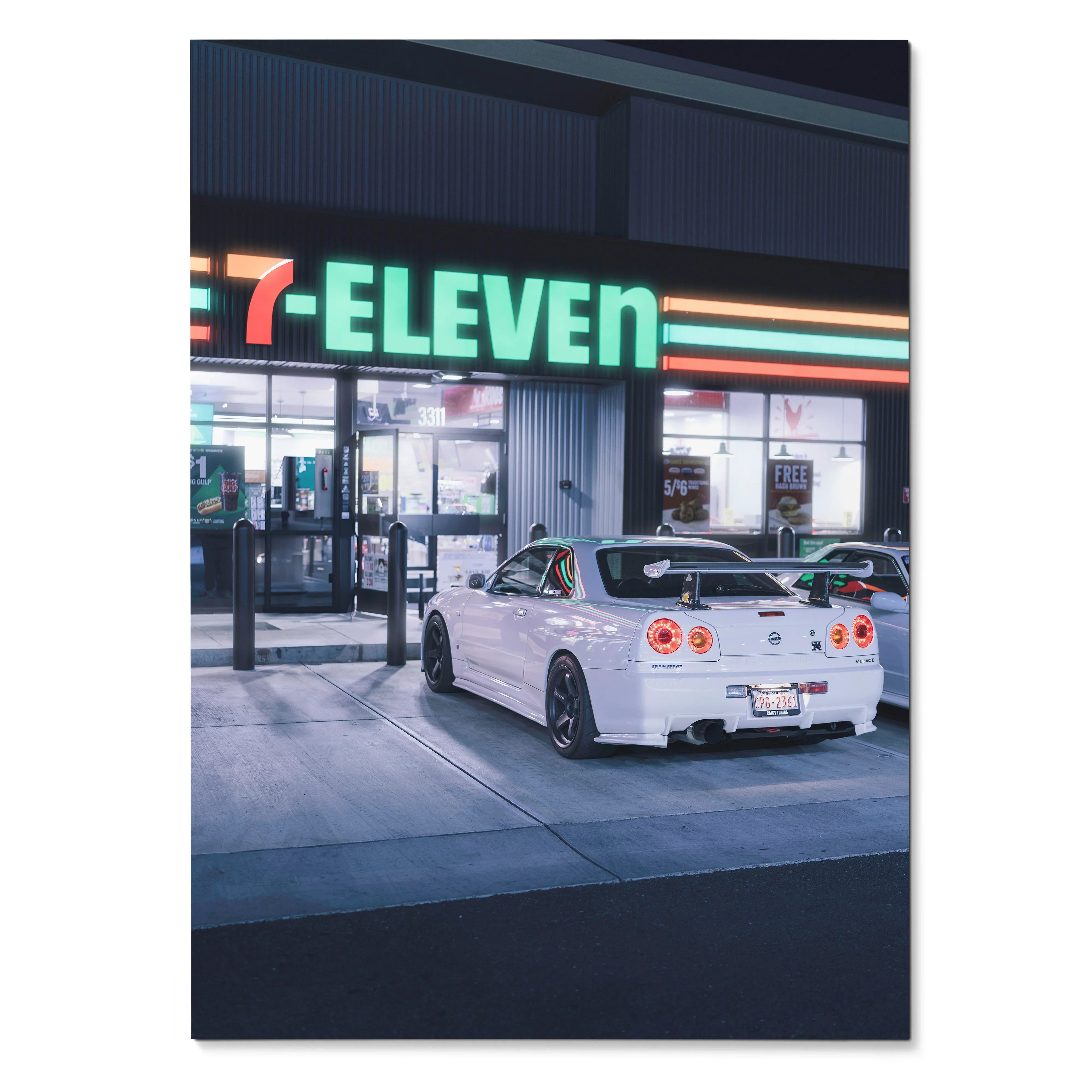 Nissan GTR R34 Skyline white car parked outside 7-Eleven at night poster wall art.