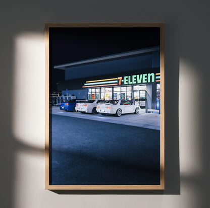 Nissan GTR R32 and R34 parked outside 7-Eleven at night poster wall art in wooden frame.