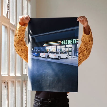 High-resolution wall art poster featuring Nissan R32 and R34 GTRs parked in front of 7-Eleven at night.