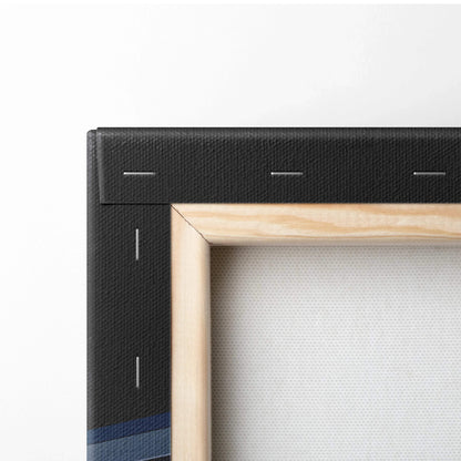 Corner detail of stretched canvas wall art with light wooden frame and black fabric backing.
