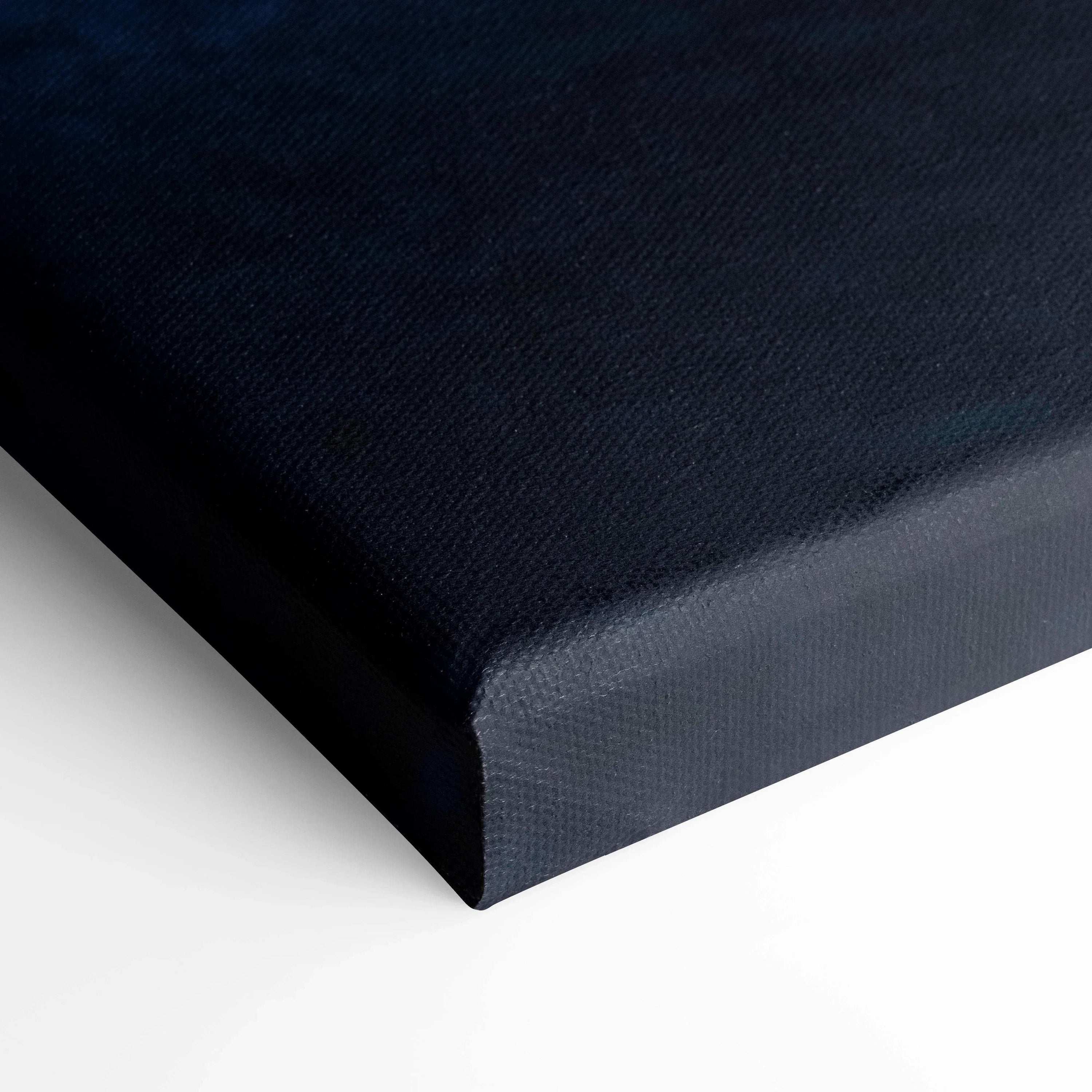 Black wrapped canvas corner with subtle texture, premium wall art canvas print detail.