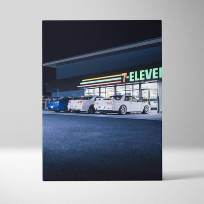 Nissan GTR R34 Skyline parked at night in front of 7-Eleven store canvas wall art.
