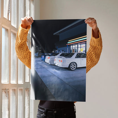 Nissan GTR Skyline poster featuring white R32 and R34 GTRs parked at night, wall art print.