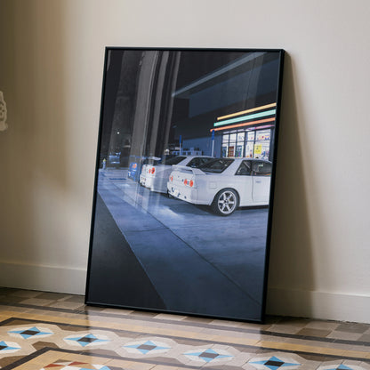Nissan GTR Skyline poster featuring white R32 and R34 GTRs at a gas station, sleek wall art.