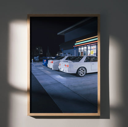 Nissan GTR Skyline poster featuring white R32 and R34 GTRs parked at night, wall art in wooden frame.