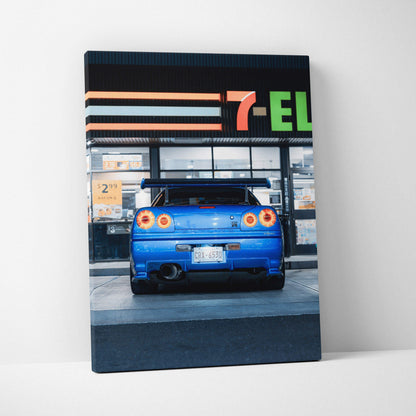 Vertical canvas wall art featuring a blue Nissan GTR R34 Skyline rear view with 7-Eleven store background.