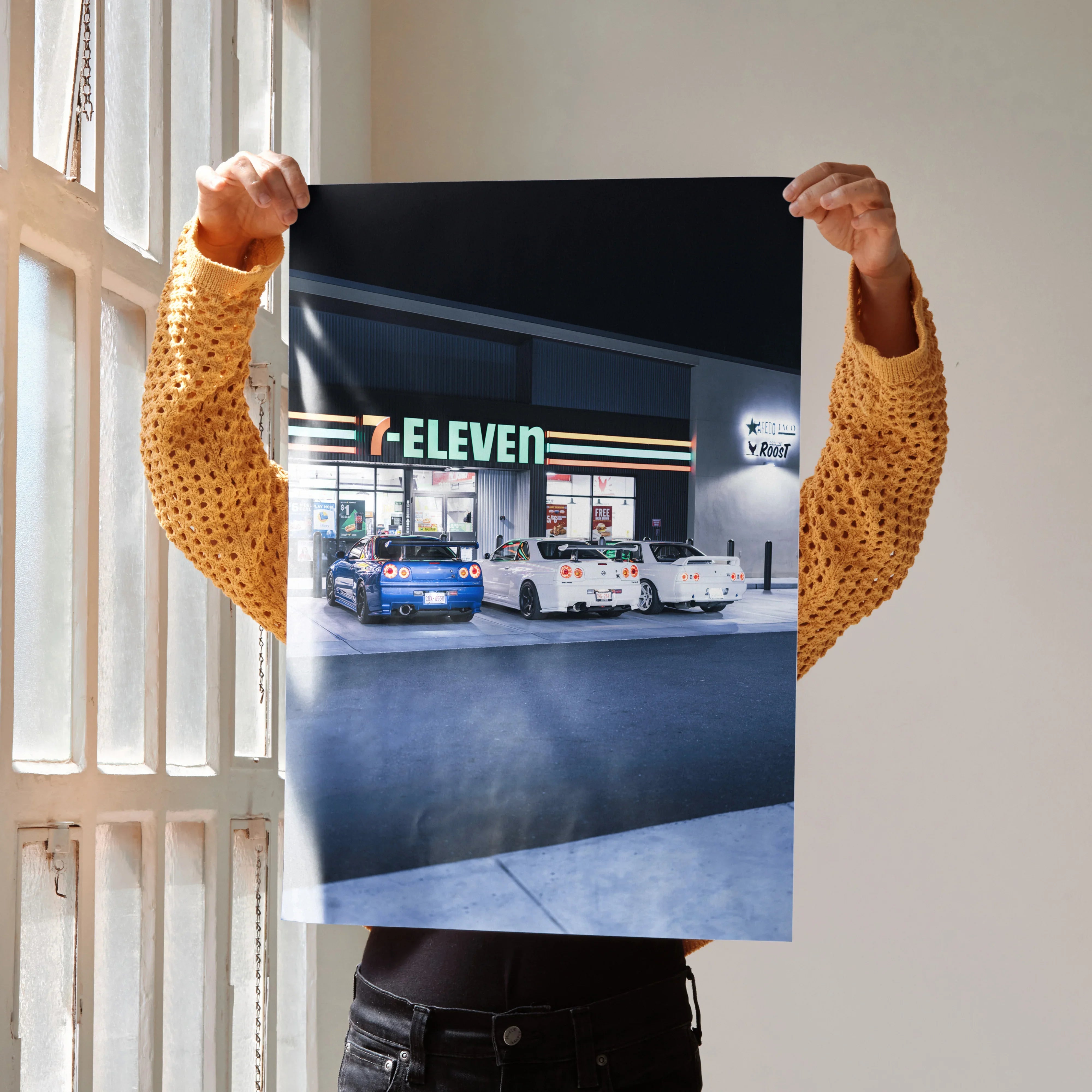 Nissan GTR R32 and R34 Skyline parked in front of 7-Eleven at night poster wall art.