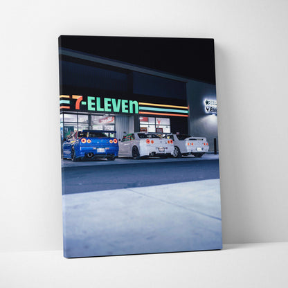 Vertical canvas art featuring three Nissan GTR R34 Skyline cars parked outside a 7-Eleven at night, high-resolution wall art.
