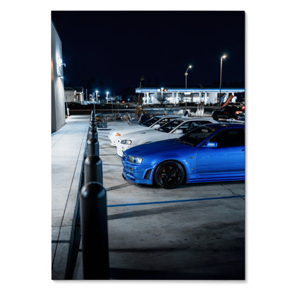 Nissan GTR Skyline R32 and R34 cars parked at night poster wall art with blue and white models.