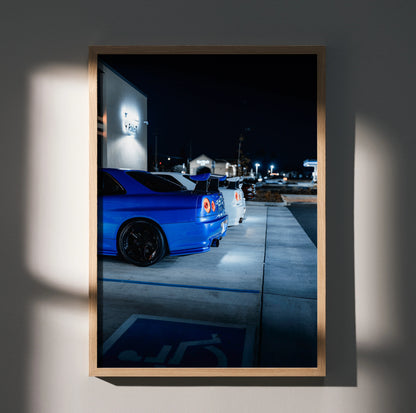 Framed poster featuring blue Nissan R34 GTR Skyline rear view at night wall art.