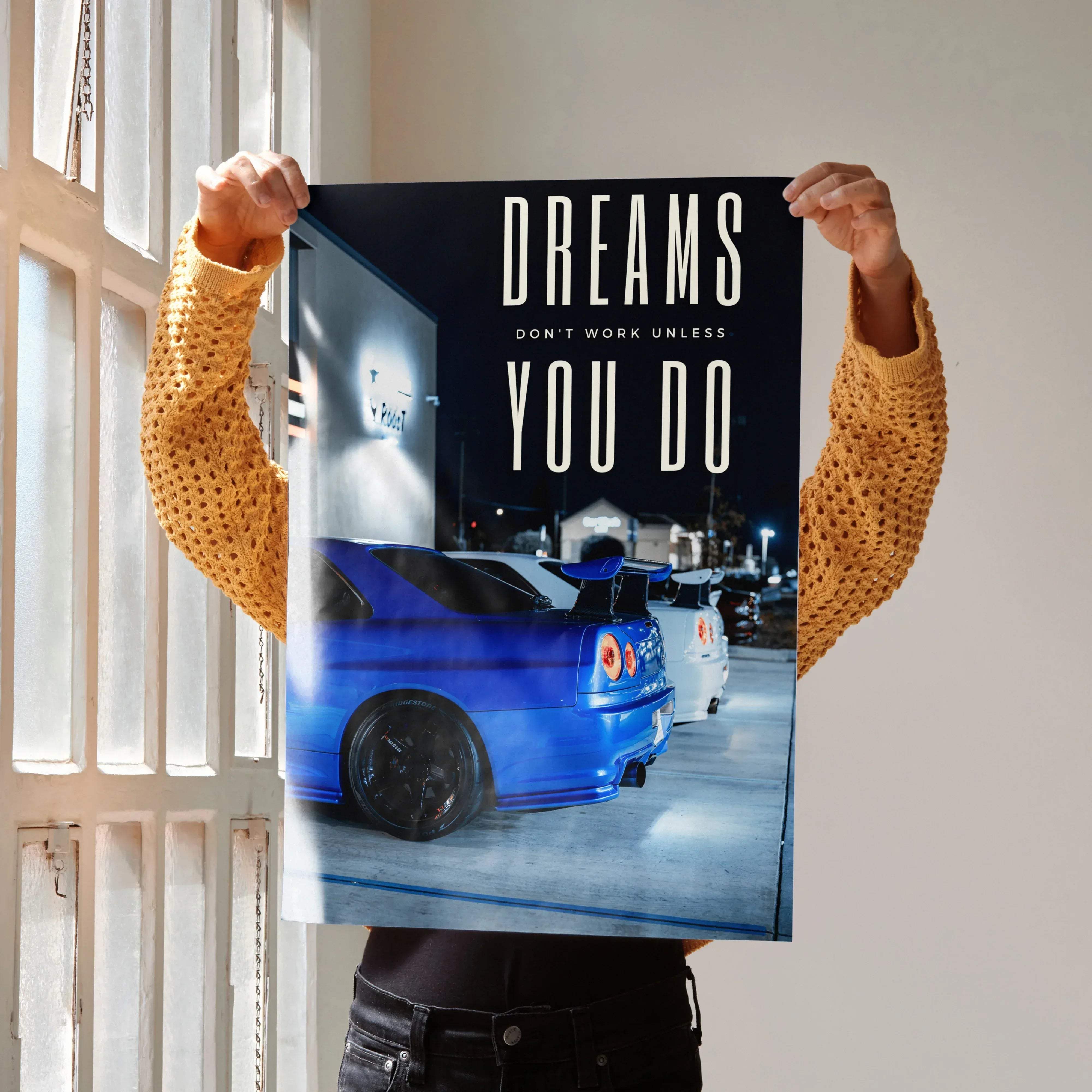 Motivational poster featuring a blue nissan gt-r r34 skyline with bold white text and black rims for decor