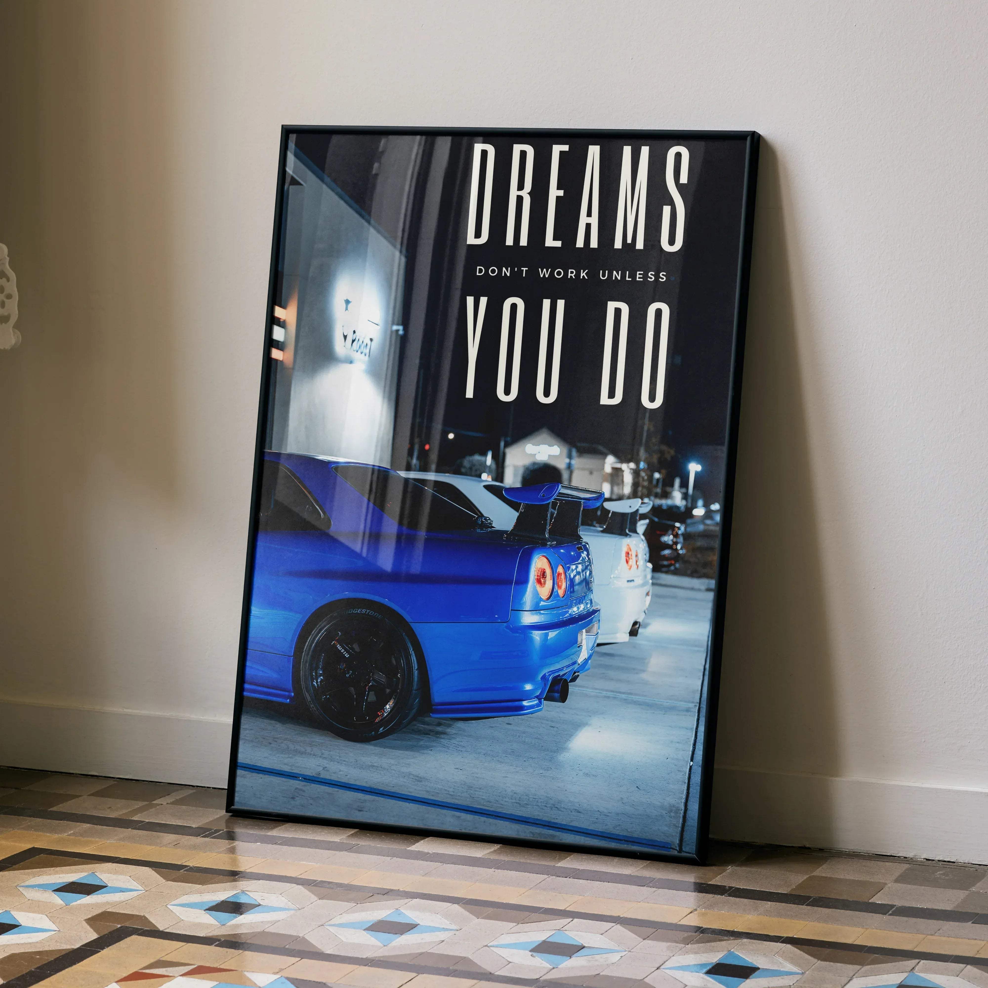 A framed motivational poster featuring a vibrant blue Nissan GT-R R34 Skyline with bold white text
