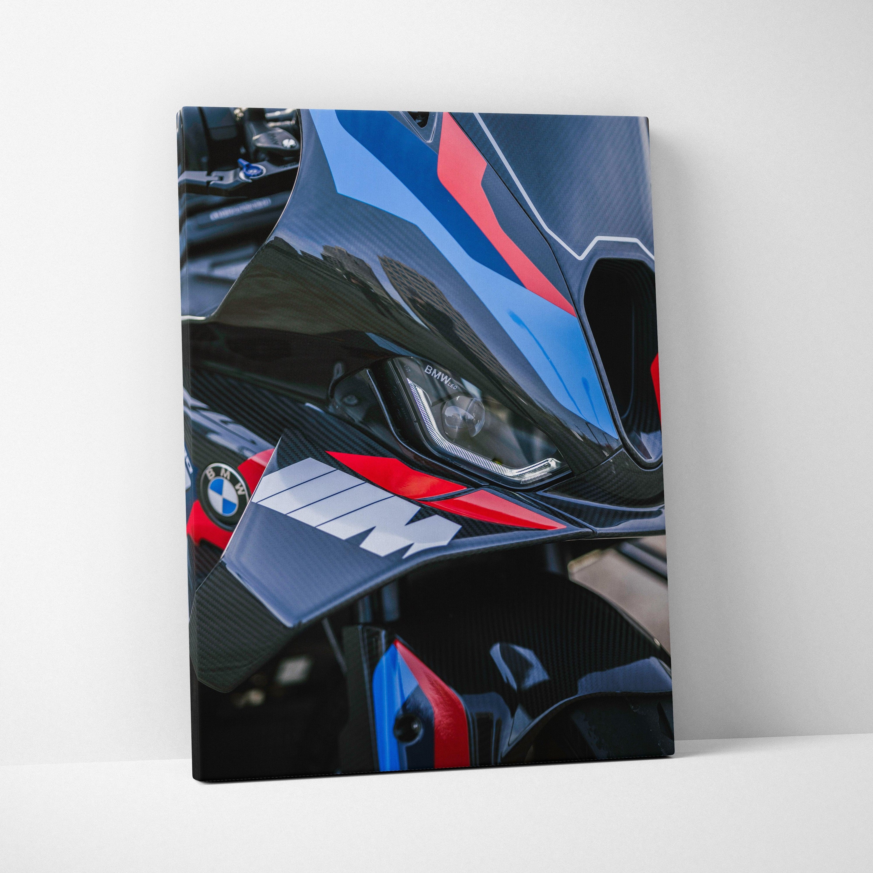 Close-up BMW M1000RR motorcycle detail canvas wall art with blue, red, and black racing colors.