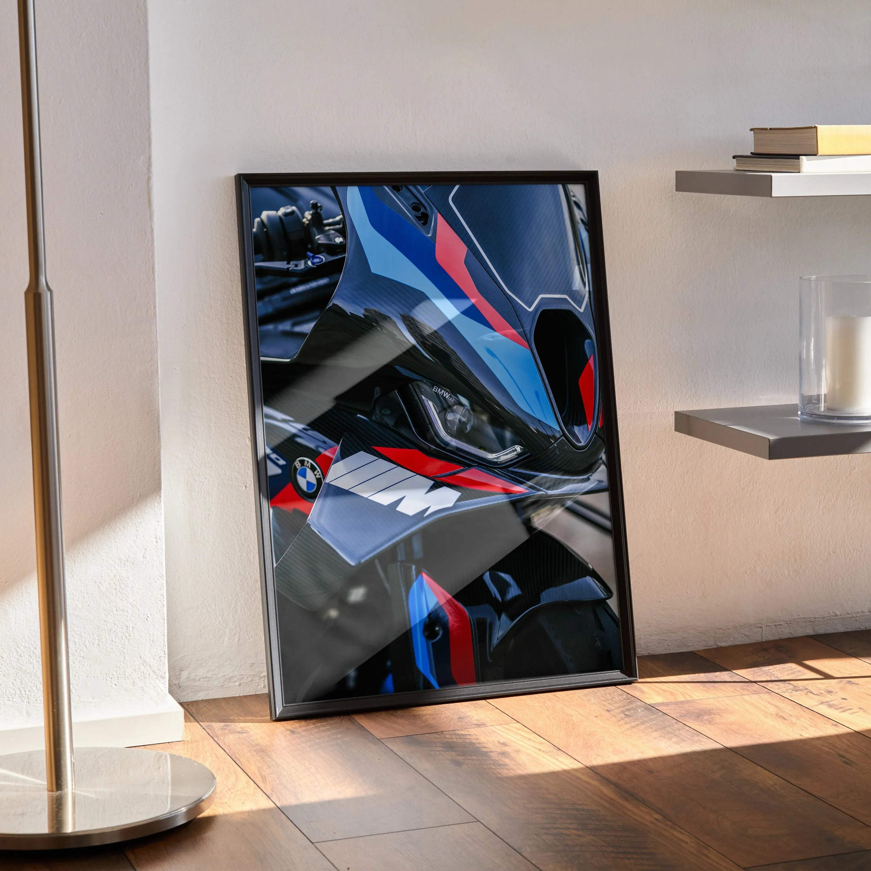 Framed BMW M1000RR motorcycle poster with blue, black, and red accents leaning against wall, modern wall art.