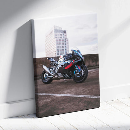 Vertical canvas art featuring a black and blue BMW M1000RR motorcycle against an urban rooftop background.