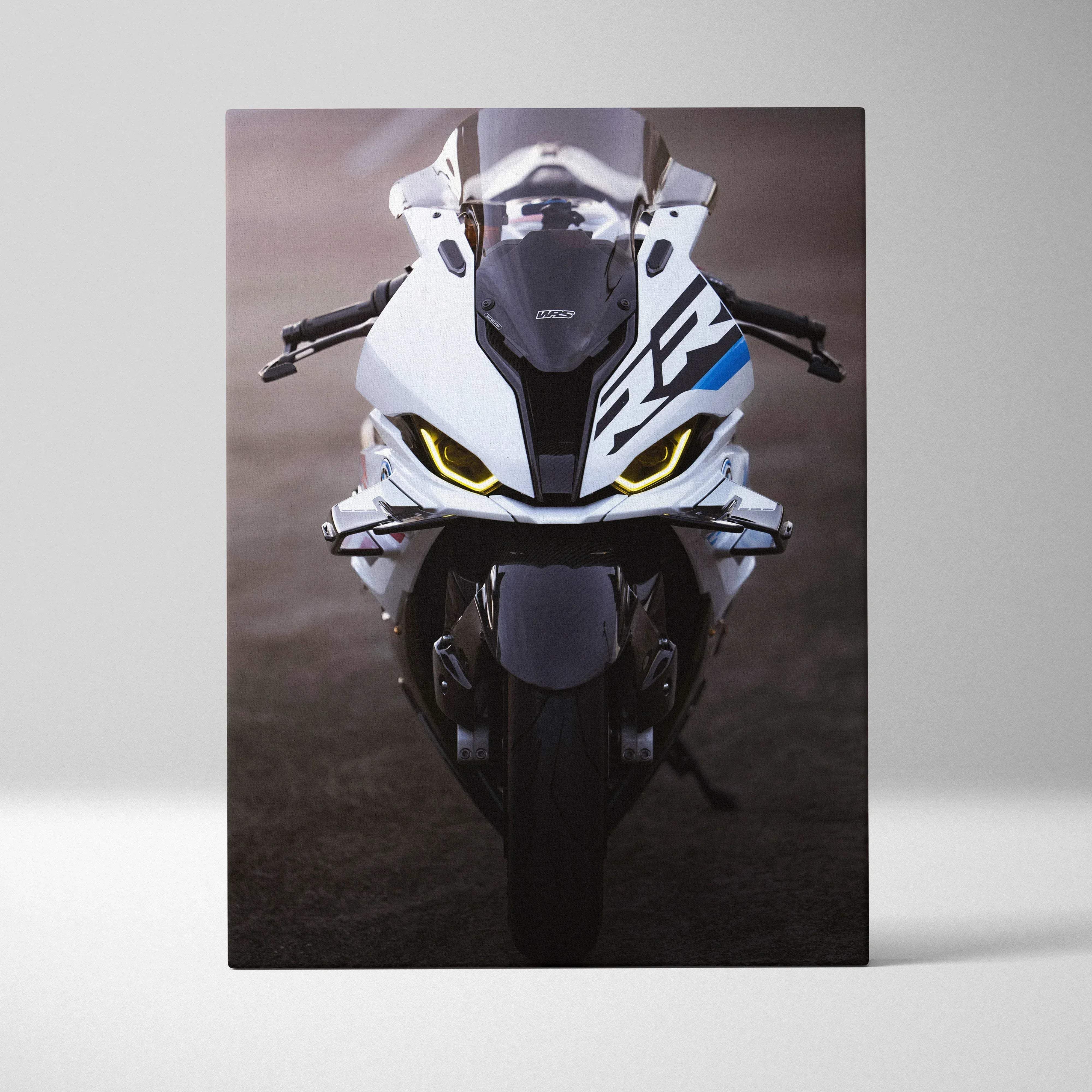 Canvas wall art high resolution vertical print featuring a white and black bmw s1000rr motorcycle with blue accents and glowing yellow headlights