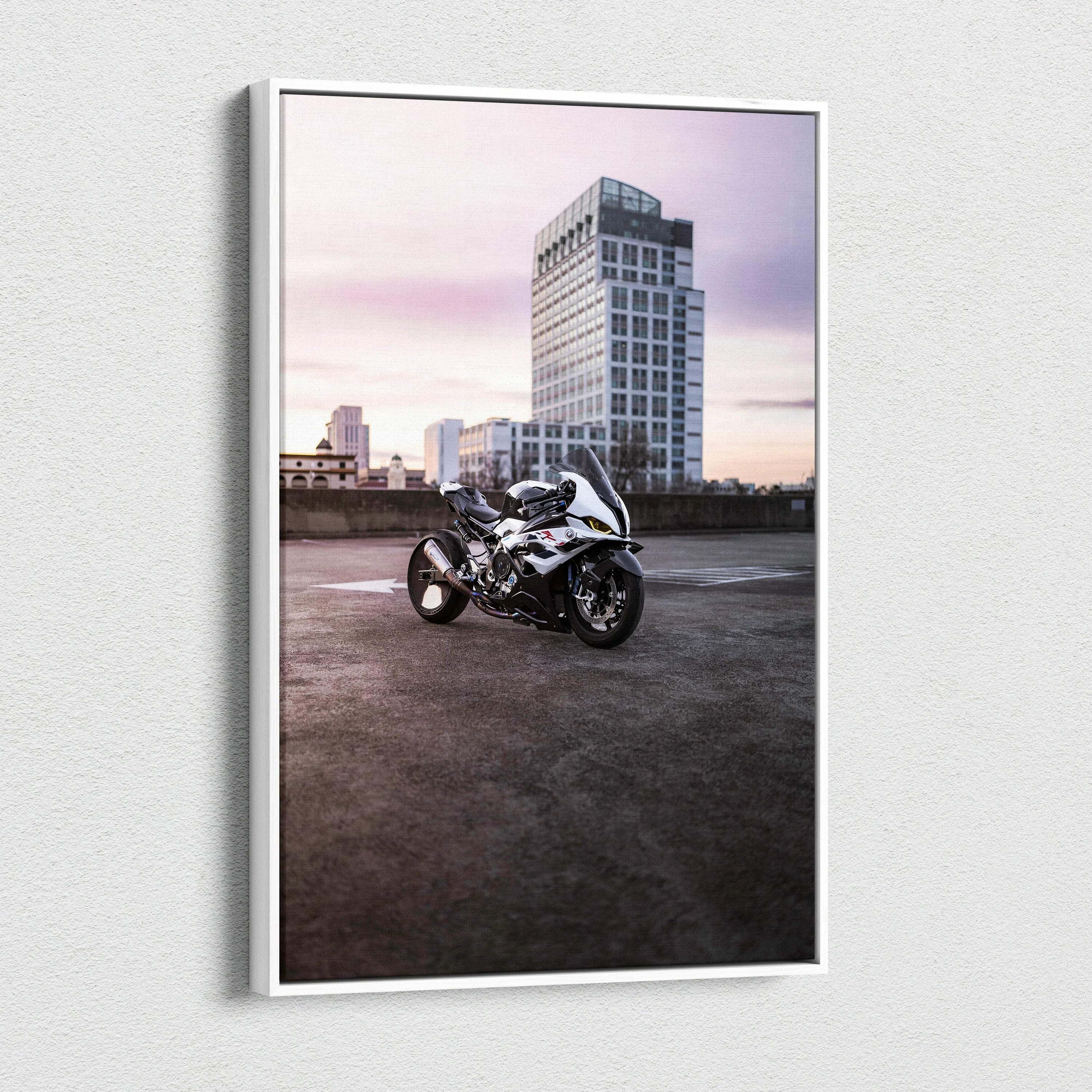 Vertical canvas wall art of a BMW S1000RR motorcycle in front of urban skyscraper at dusk.