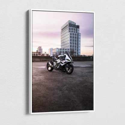 Vertical canvas wall art of a BMW S1000RR motorcycle in front of urban skyscraper at dusk.