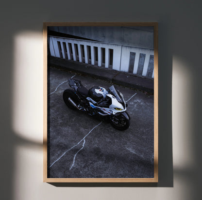 BMW S1000RR Drag Spec motorcycle wall art poster in black, white, and blue tones with dynamic urban background.