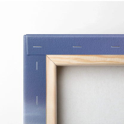 Close-up of blue canvas art corner with wooden stretcher bars and metal staples for wall art display.