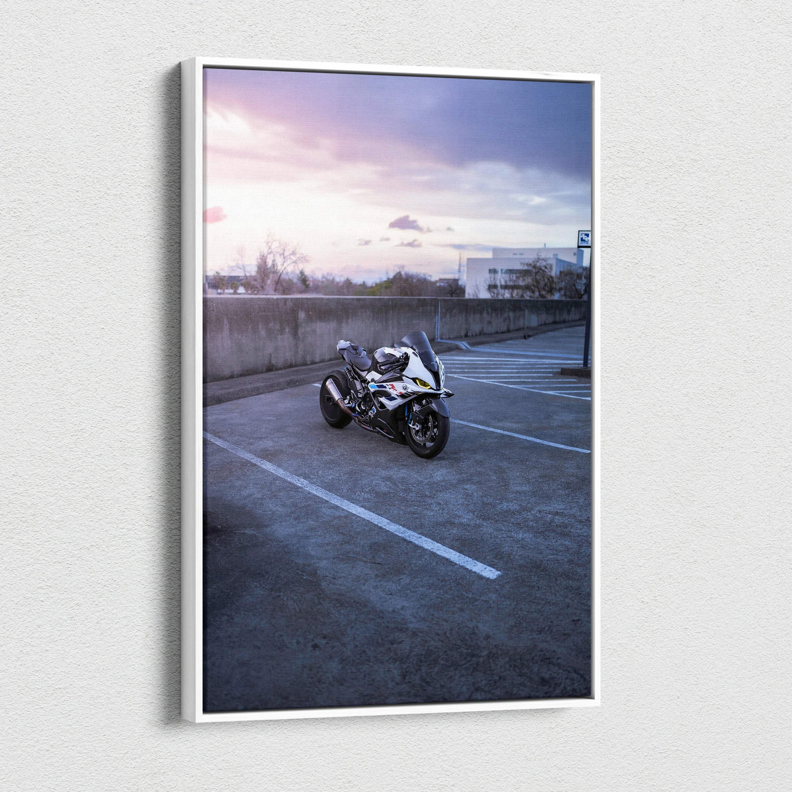 Vertical canvas wall art featuring a BMW S1000RR motorcycle in an empty parking lot at sunset.