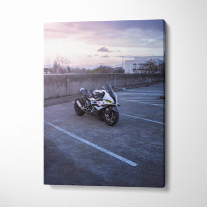 BMW S1000RR motorcycle canvas wall art with sunset background and modern parking lot setting.
