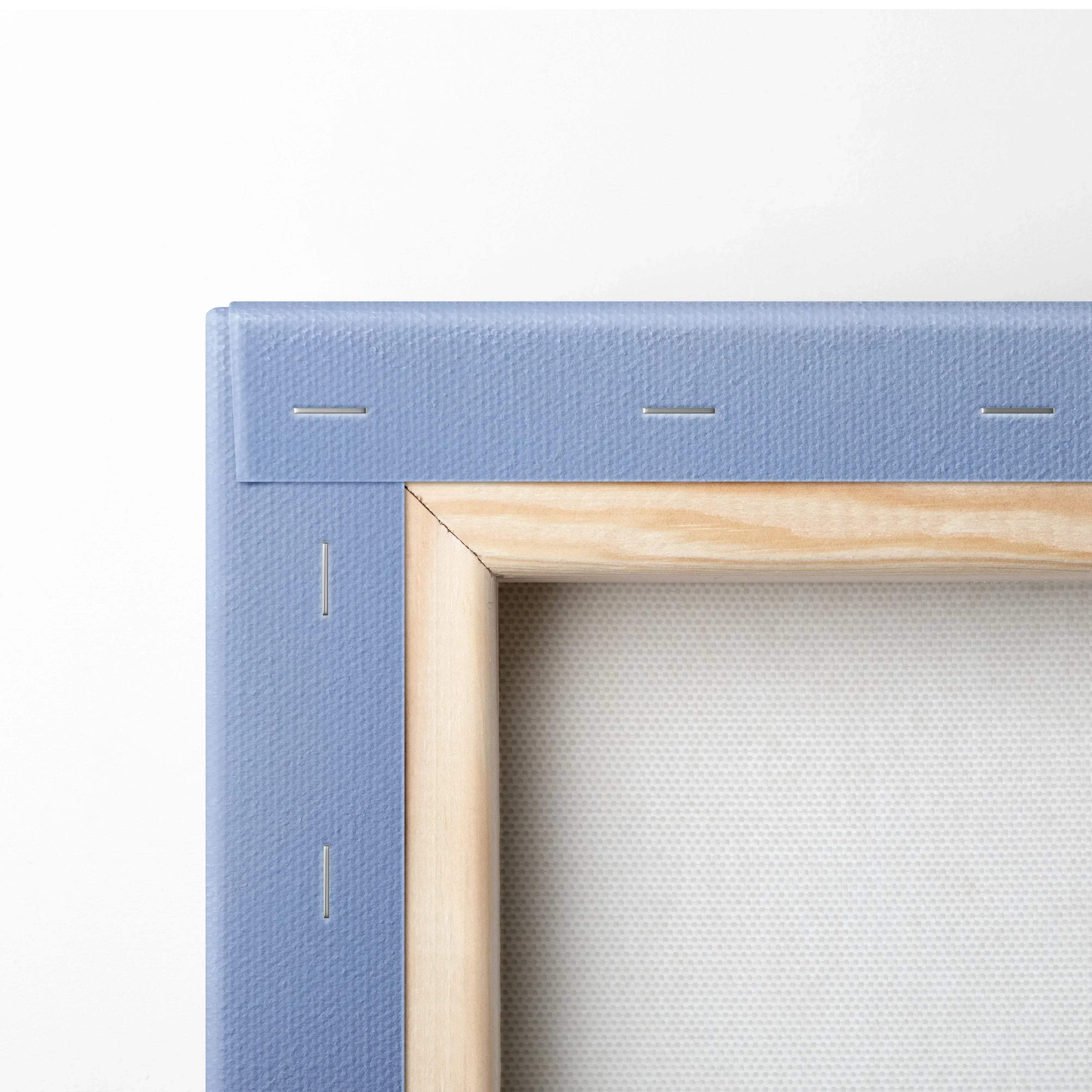 Close-up of museum-quality canvas wall art corner with natural wood frame and blue linen backing.
