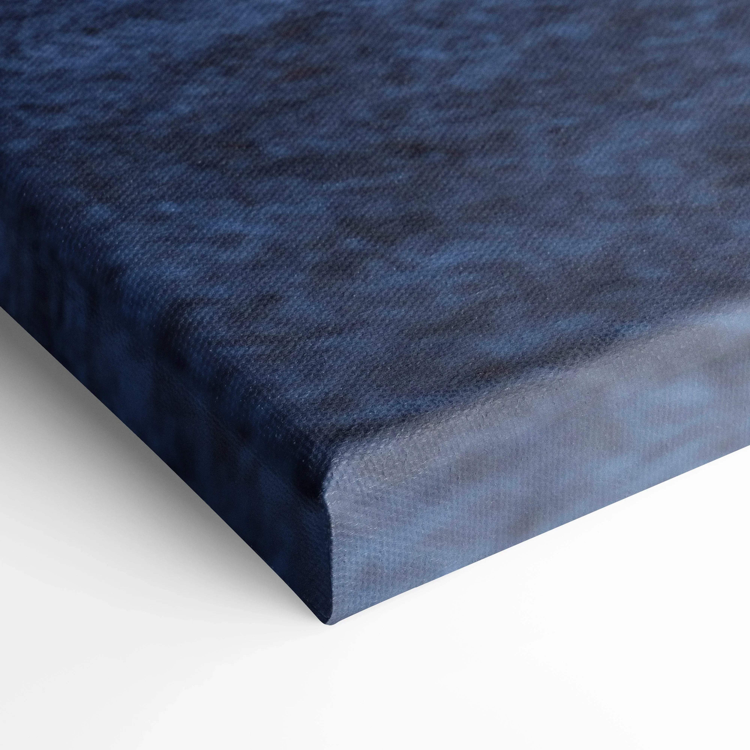 Close-up of textured blue canvas edge highlighting high-quality wall art material.