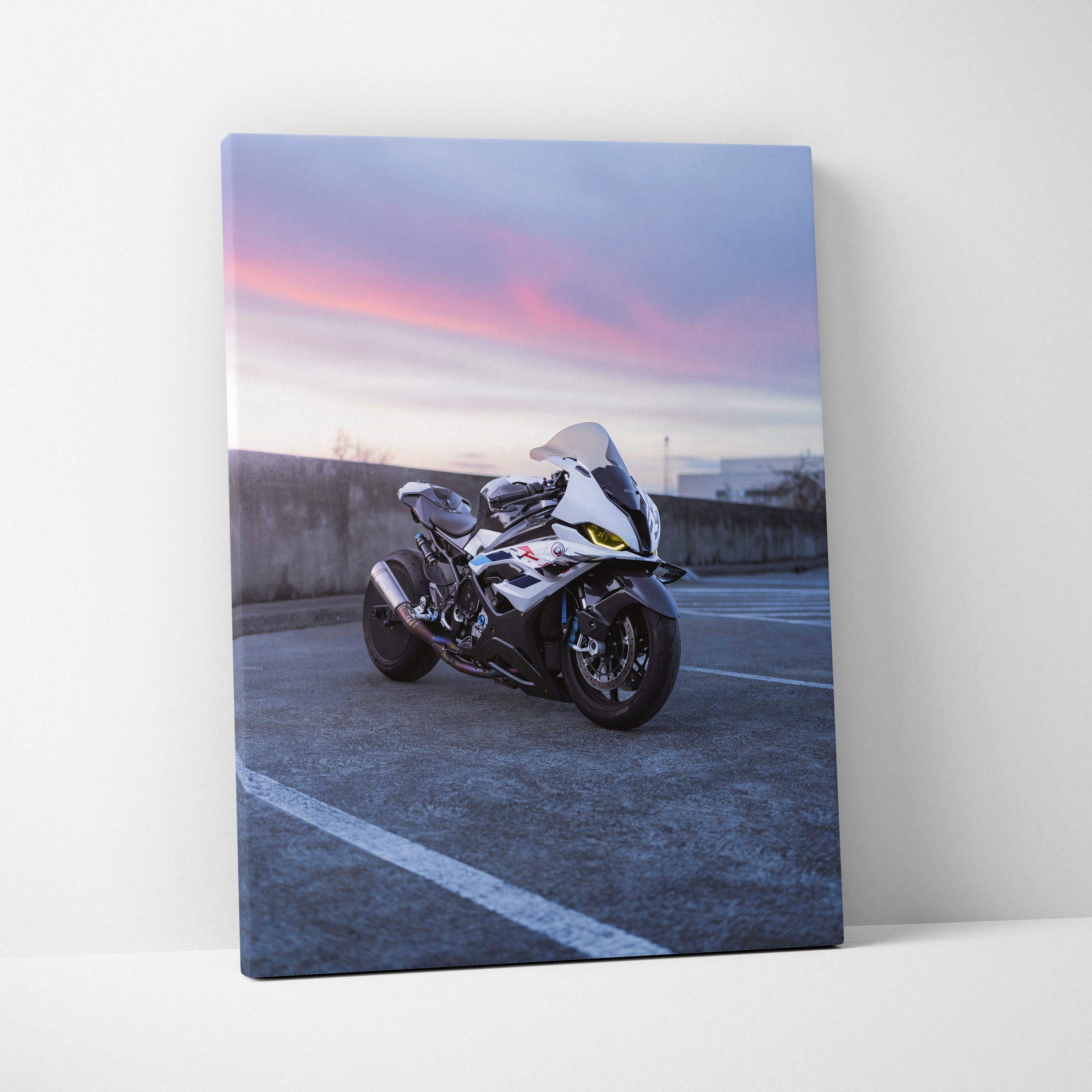 Vertical canvas wall art featuring a BMW S1000RR motorcycle against a purple and pink sunset sky.