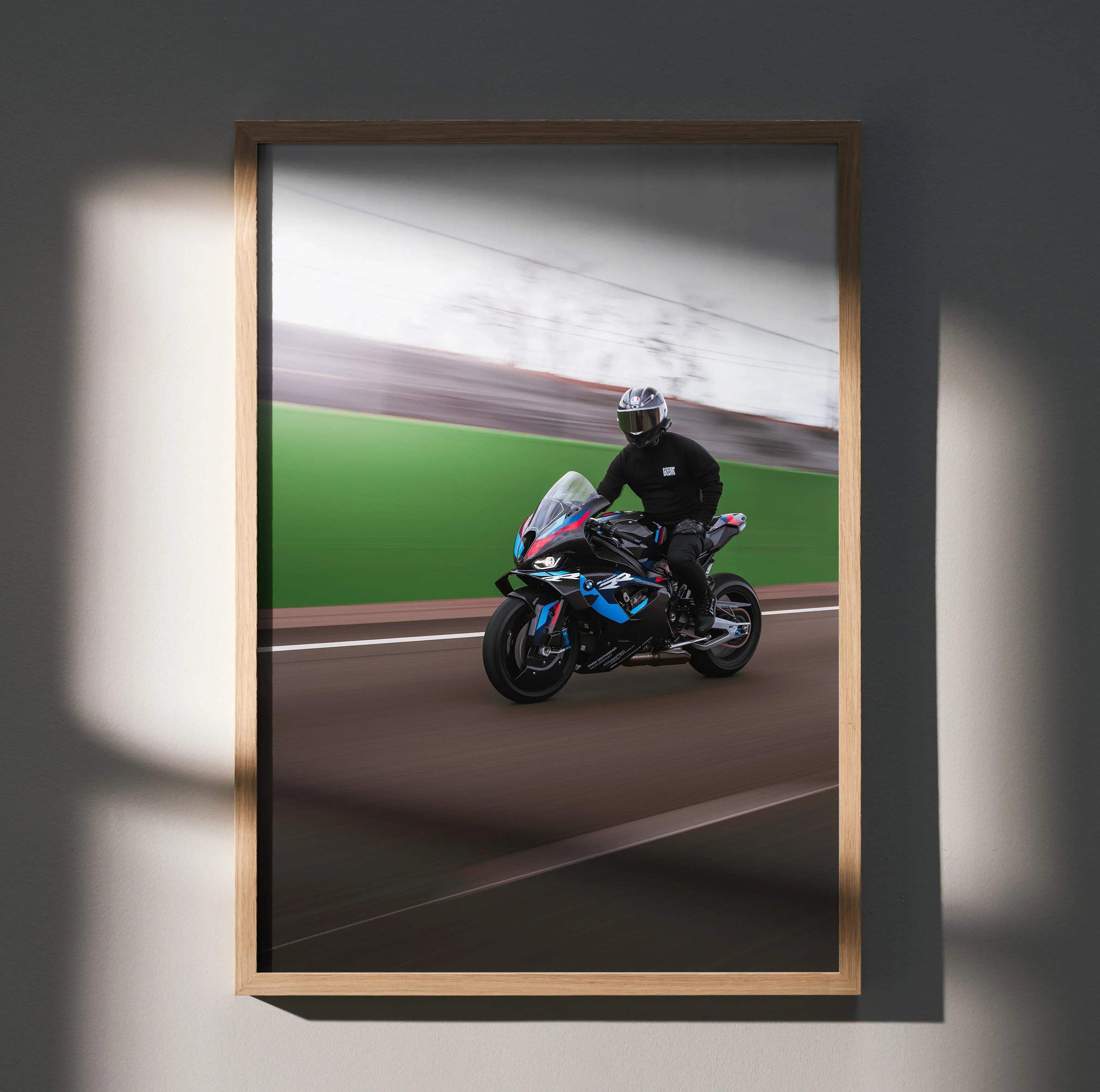 BMW M1000RR motorcycle poster with rider on racetrack, dynamic wall art in wooden frame.