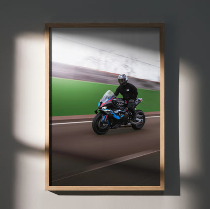 BMW M1000RR motorcycle poster with rider on racetrack, dynamic wall art in wooden frame.