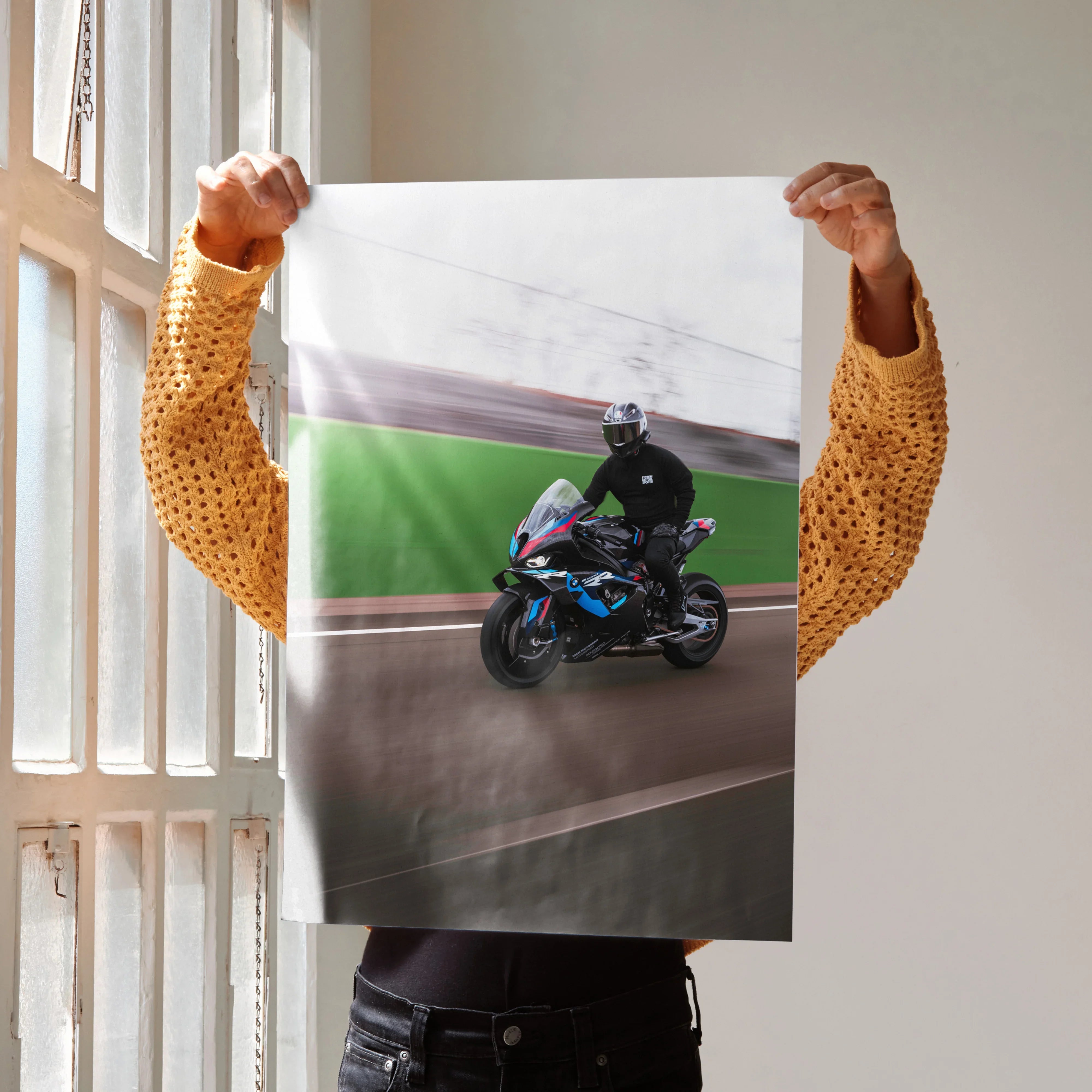 BMW M1000RR motorcycle poster with rider in black gear on racetrack wall art print.