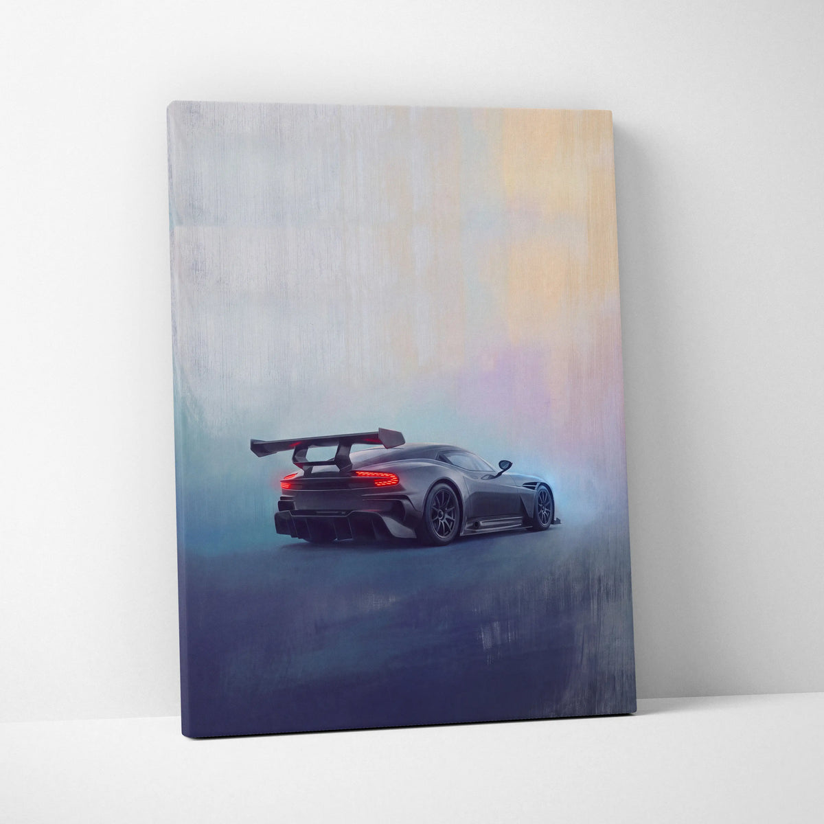 Aston Martin Vulcan inspired canvas art featuring a sleek dark gray sports car with a rear spoiler and glowing taillights