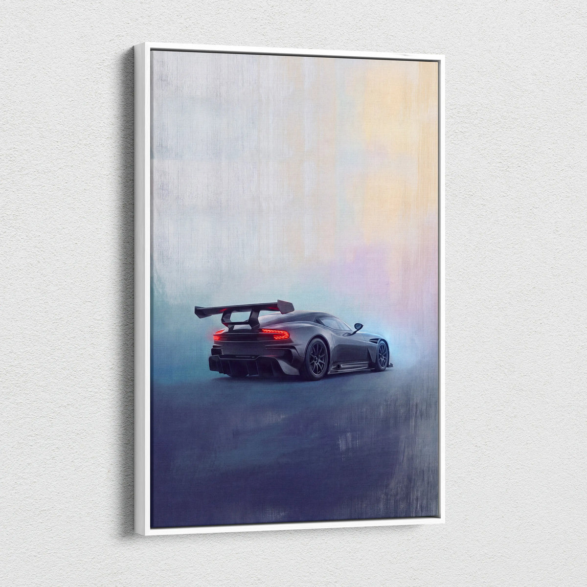 Auston martin vulcan inspired canvas art featuring a sleek dark gray racing car with rear spoiler in a white frame