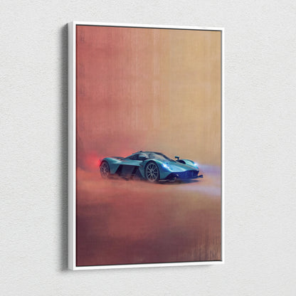 A framed canvas print of a turquoise Aston Martin Valkyrie sports car in motion on a warm red and orange gradient background